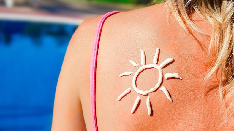 happy girl with the sun on her back at the pool in the nature