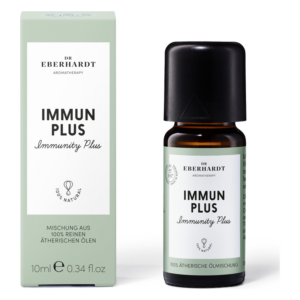 Eine Flasche ätherisches Öl mit der Aufschrift "IMMUN PLUS" sowie die passende Verpackung in sanften Farben.