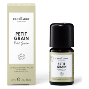 Eine Flasche ätherisches Öl "Petit Grain" in einer schwarzen Verpackung neben einer hellgrünen Schachtel mit weißem Text.